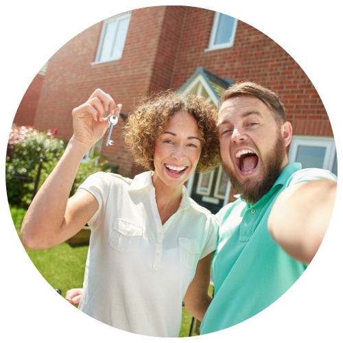 image of a male and female in front of a house, she is holding up keys to the house, both have an excited and joyful look on their faces